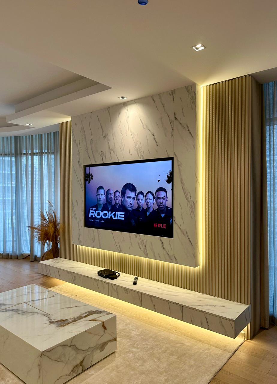 Stylish TV wall panel with floating wooden console and warm backlighting