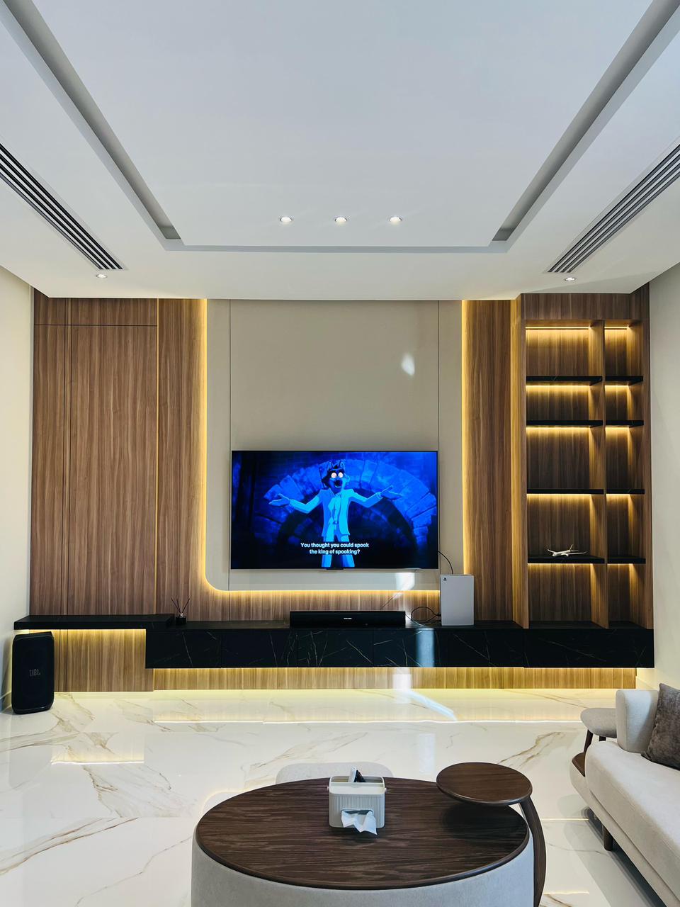 Stylish TV wall panel with floating wooden console and warm backlighting